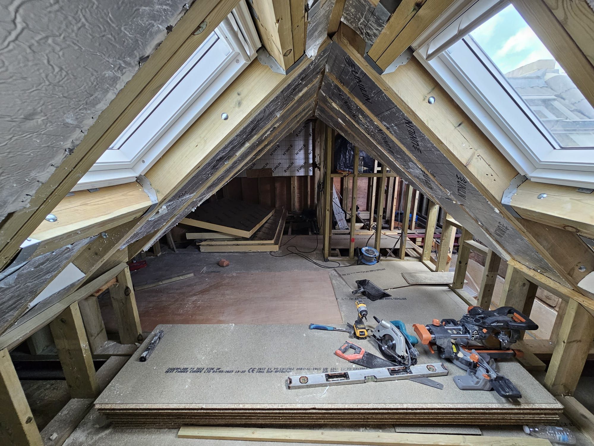 Loft conversion in progress with twin Velux skylight windows fitted by JFA Construction Group