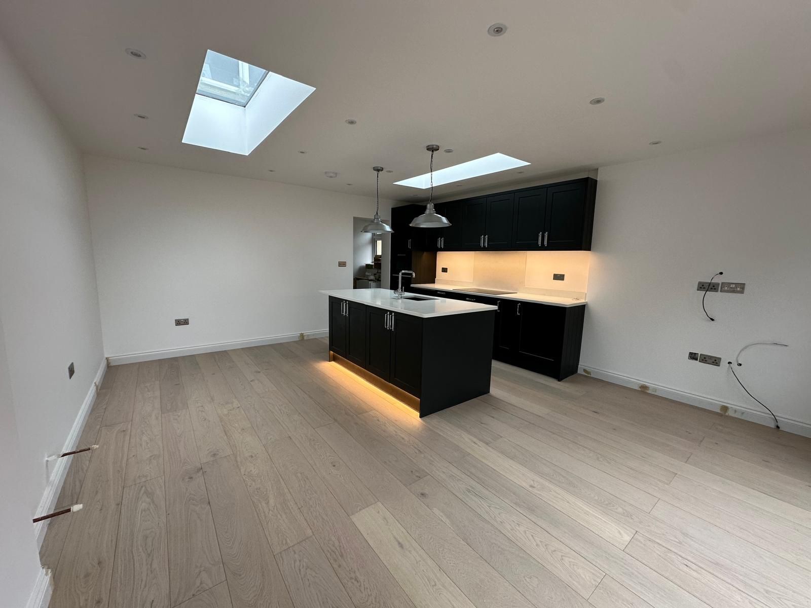Open-plan living and kitchen space after a full home renovation by JFA Construction Group