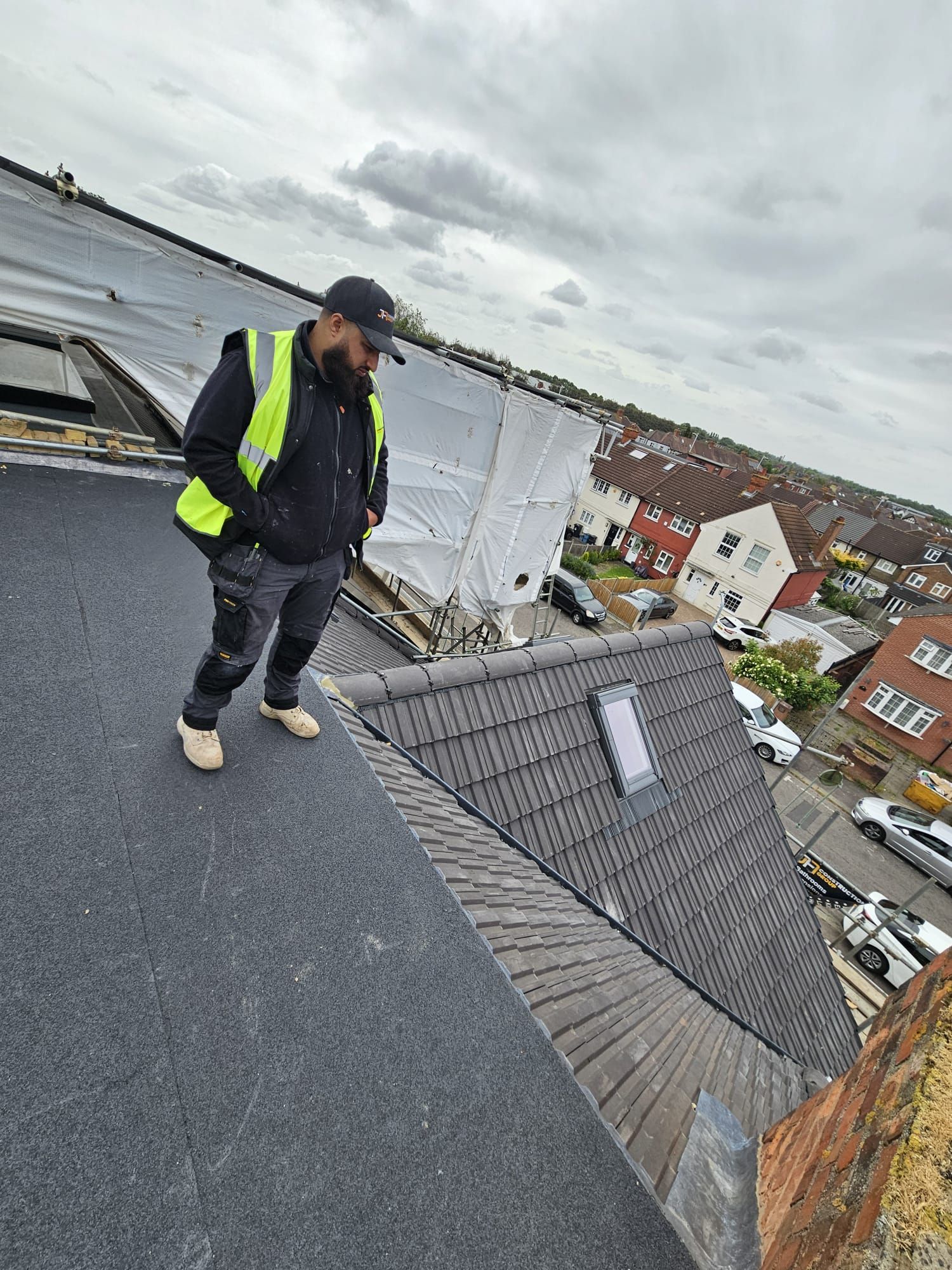 JFA Construction Group roofer working on site above the London rooftops