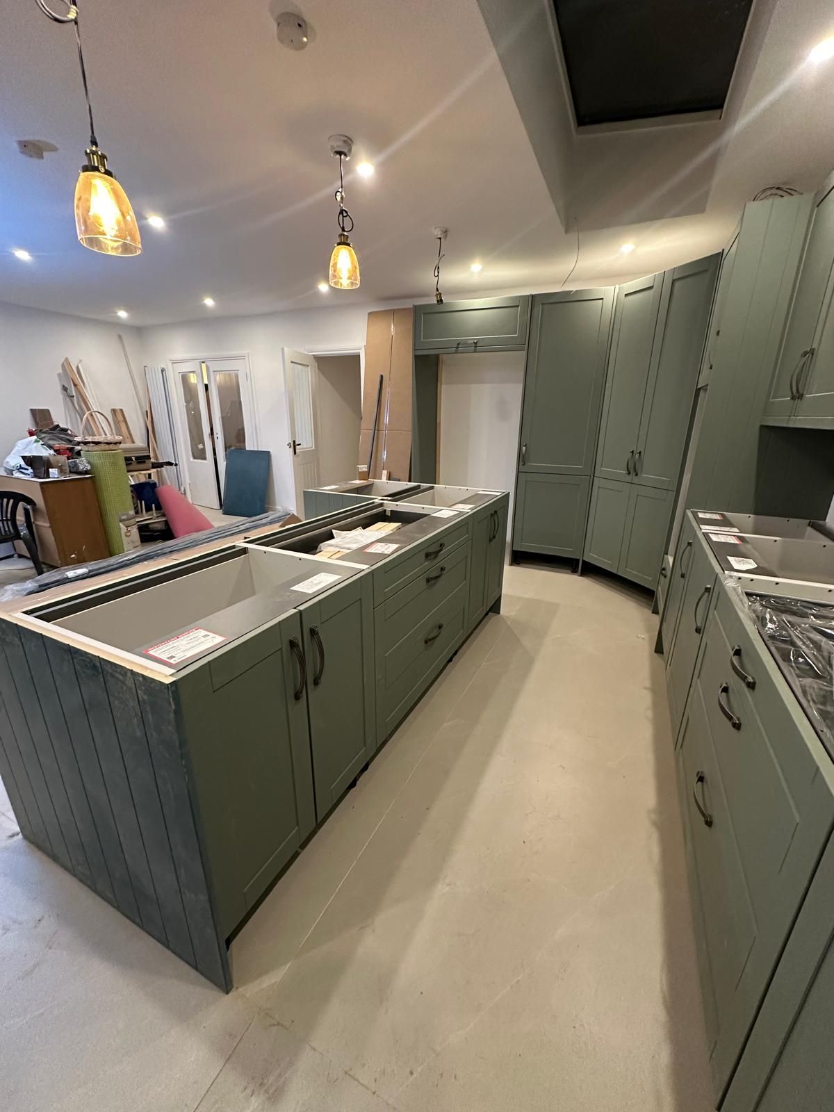 Sage green galley kitchen renovation completed by JFA Construction Group in Chingford
